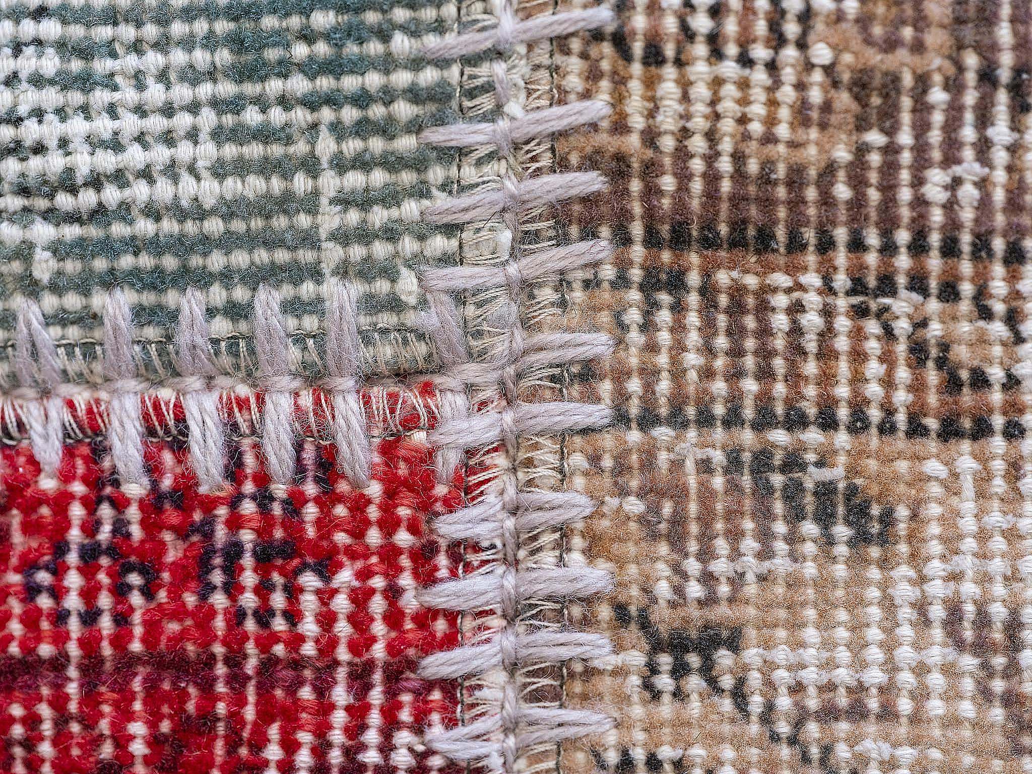 Detailed close-up of a vibrant woven textile showcasing intricate patterns and stitching.