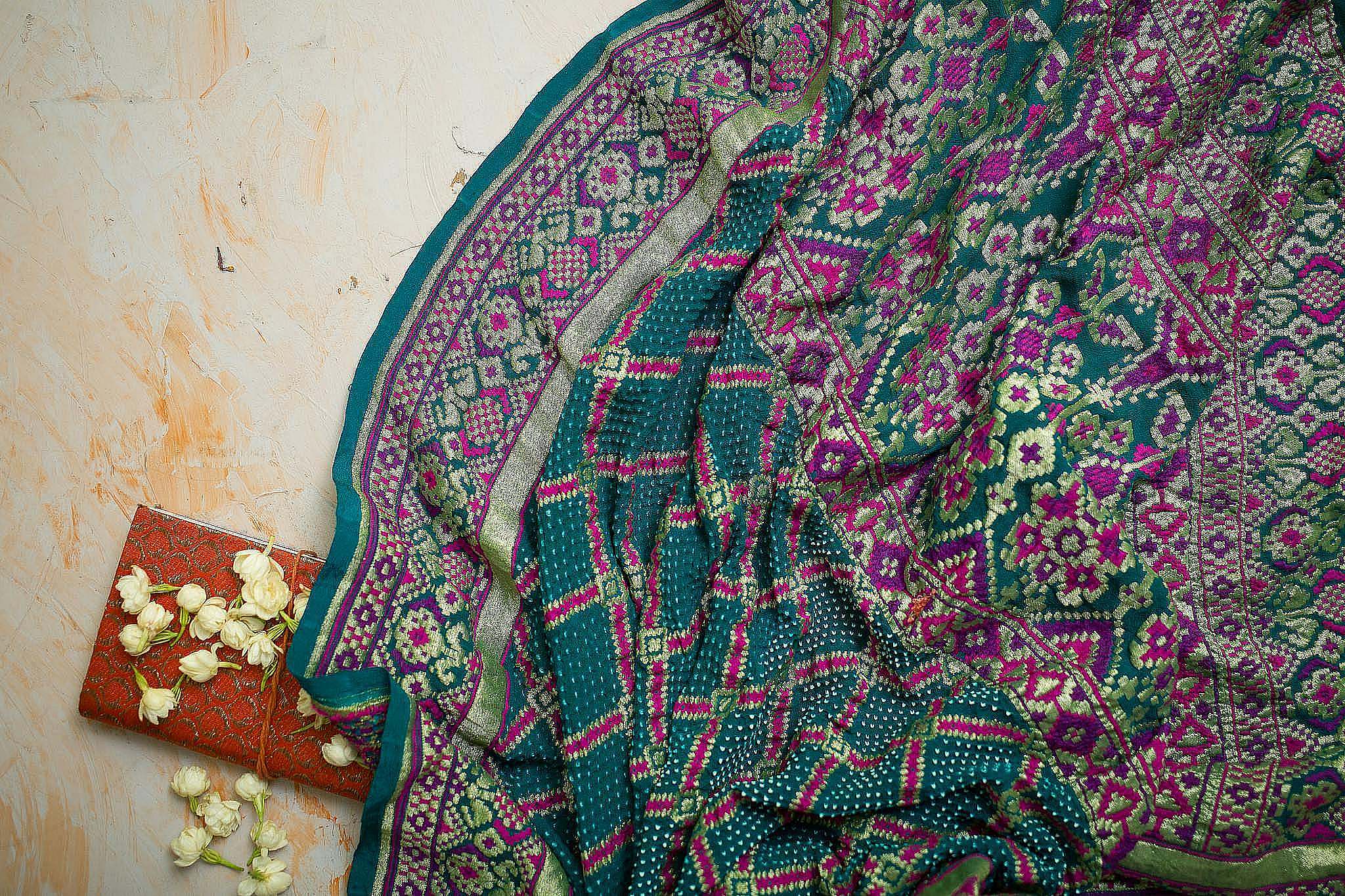 Intricate traditional textile featuring vibrant patterns and floral accents. Perfect for cultural and fashion themes.